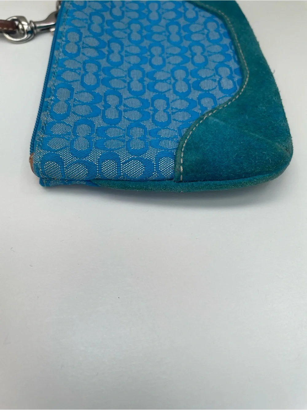 Coach Vintage Wristlet with Suede on the bottom.